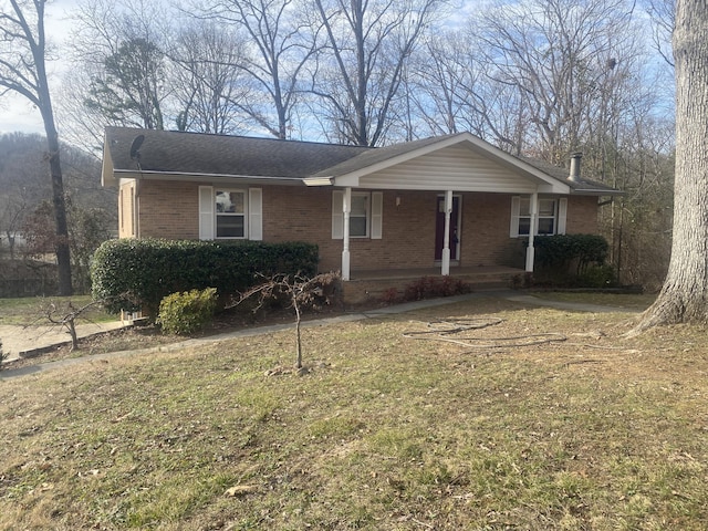 ranch-style home with a front lawn and covered porch