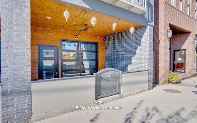 exterior space with a gate and brick siding