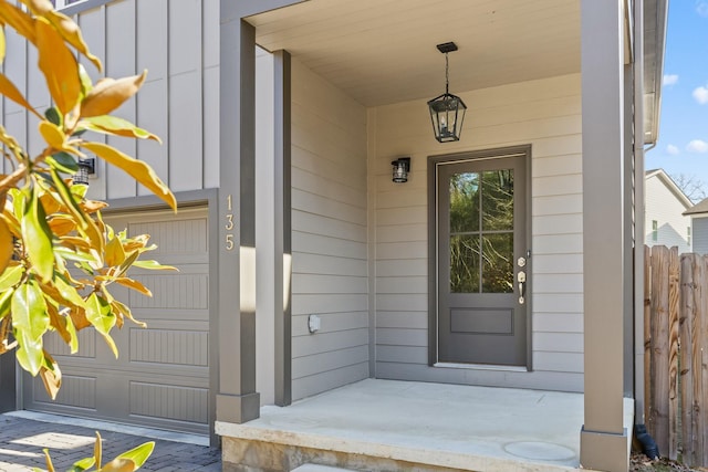 doorway to property featuring board and batten siding and covered porch