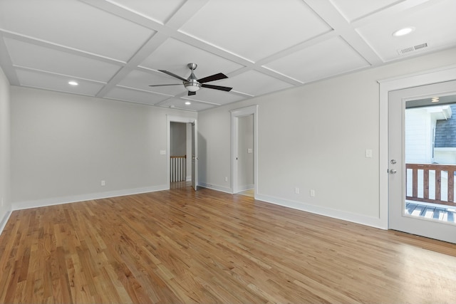 empty room with light wood-type flooring, baseboards, visible vents, and coffered ceiling