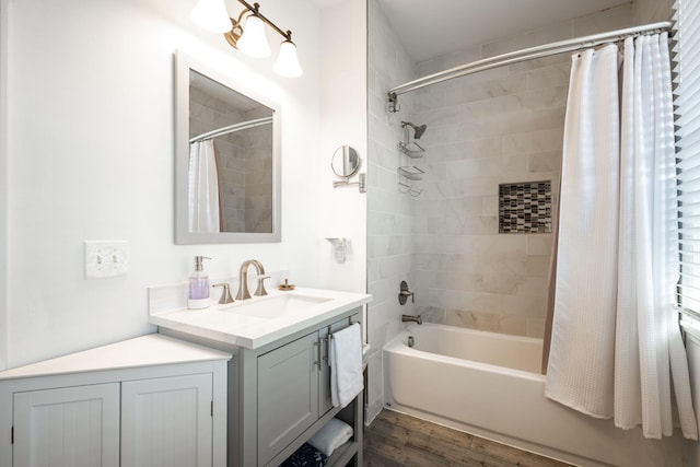 bathroom with hardwood / wood-style flooring, vanity, and shower / bathtub combination with curtain