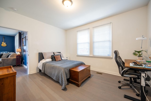 bedroom with hardwood / wood-style floors