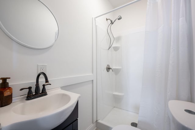 bathroom featuring vanity, toilet, and a shower with shower curtain