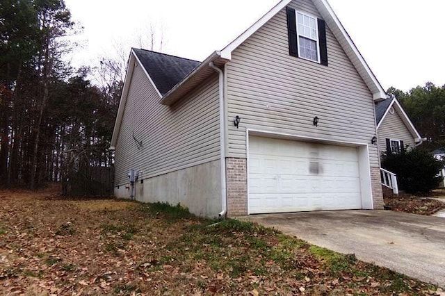 view of side of home featuring a garage