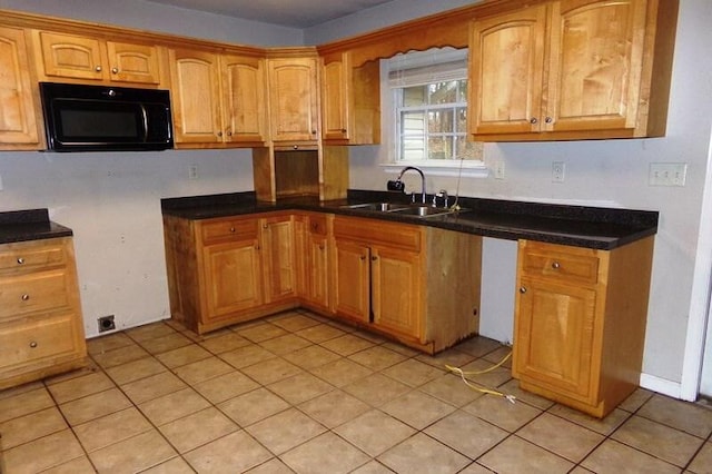 kitchen featuring sink and light tile patterned floors