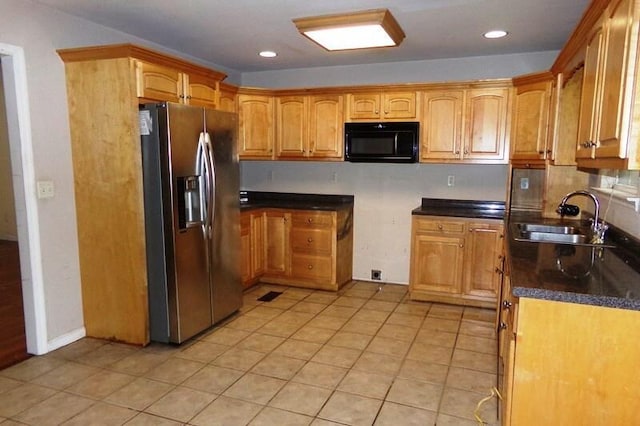 kitchen with sink, stainless steel fridge, and light tile patterned flooring