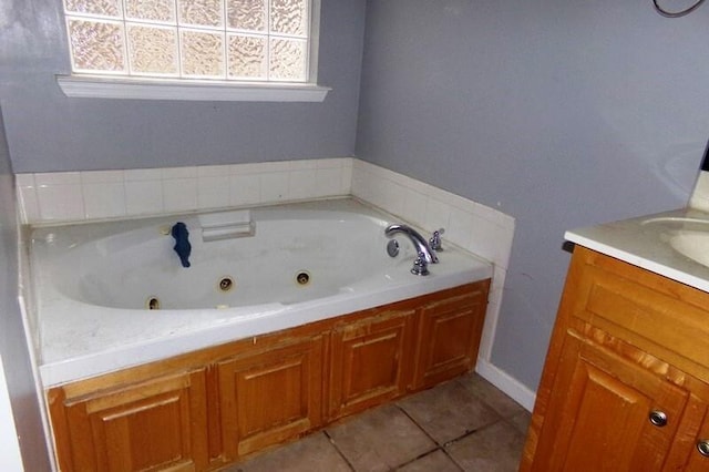 bathroom featuring vanity, a bath, and tile patterned flooring