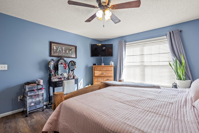 bedroom with ceiling fan, dark hardwood / wood-style floors, and a textured ceiling