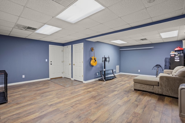 interior space with hardwood / wood-style flooring and a drop ceiling