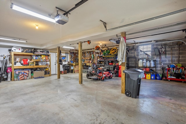 garage featuring a garage door opener and a workshop area