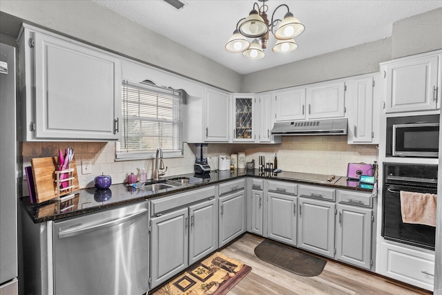 kitchen with white cabinetry, sink, and black appliances