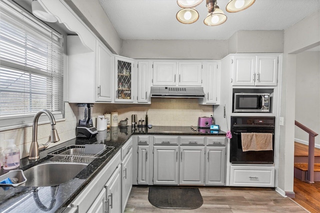 kitchen featuring sink, white cabinets, and black appliances