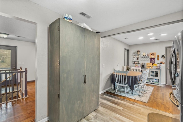 dining area featuring hardwood / wood-style floors and a textured ceiling