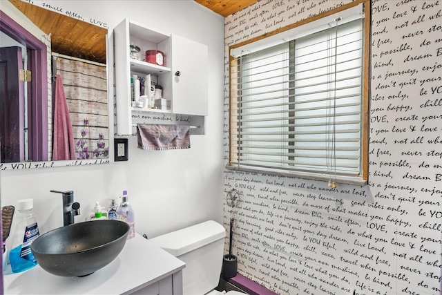 bathroom featuring vanity, toilet, and walk in shower