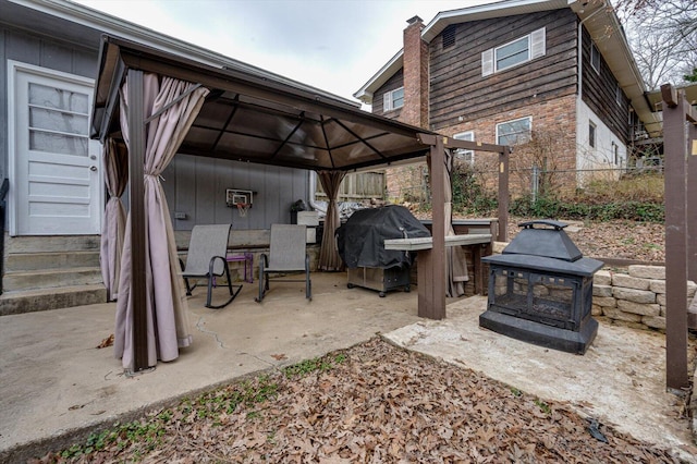 view of patio featuring a fire pit, a gazebo, and area for grilling