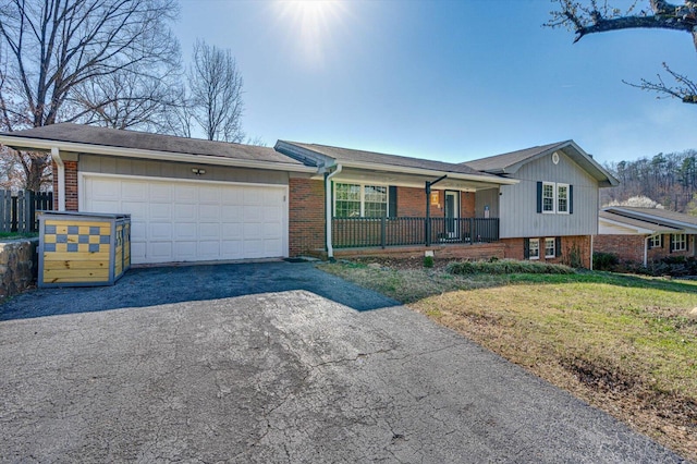 view of front of property with a front lawn, driveway, a porch, an attached garage, and brick siding