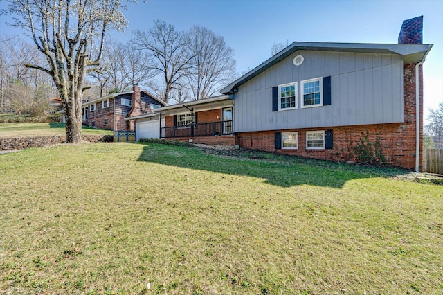 view of front facade featuring a front lawn, brick siding, an attached garage, and a chimney