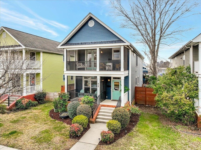 view of front facade with a sunroom and a front yard