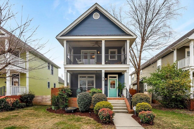 view of front of property with a sunroom and a front yard