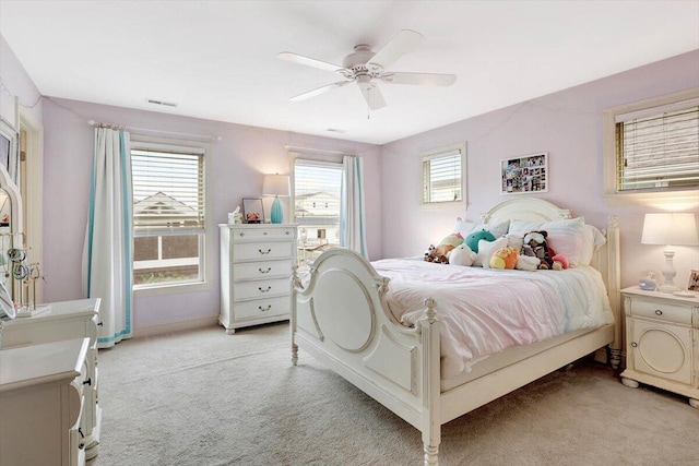 bedroom featuring light colored carpet and ceiling fan