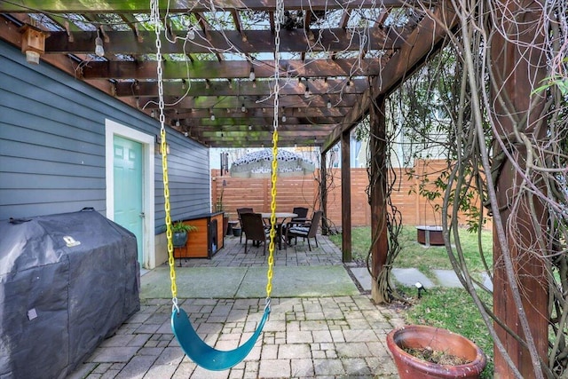 view of patio with a grill and a pergola