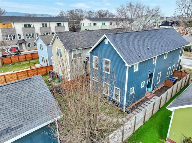 rear view of house with central AC unit