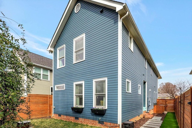 rear view of house featuring a yard