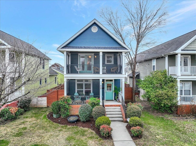 view of front of house featuring a sunroom and a front yard