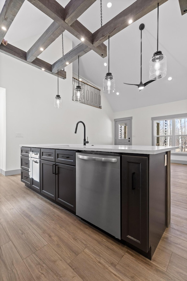 bar with light wood-type flooring, pendant lighting, dishwasher, and beamed ceiling