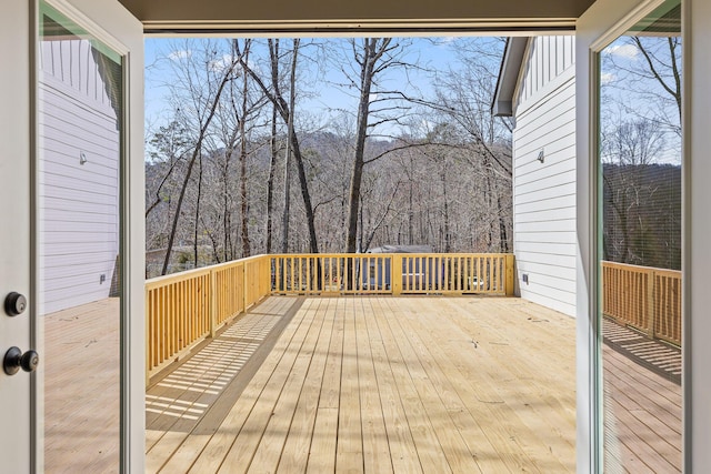 wooden deck featuring a view of trees