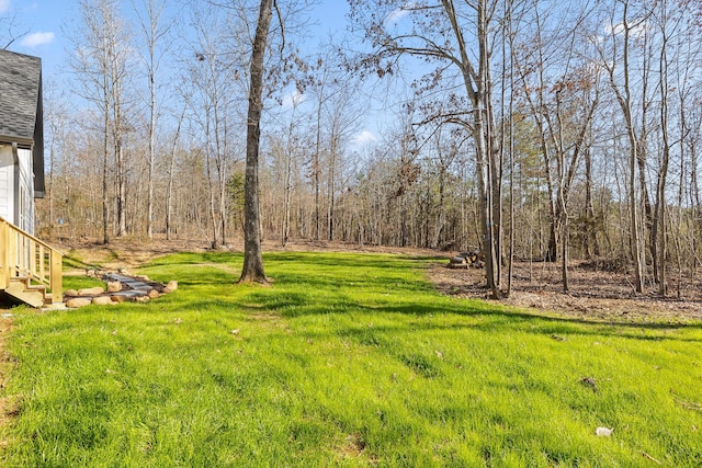 view of yard featuring a wooded view