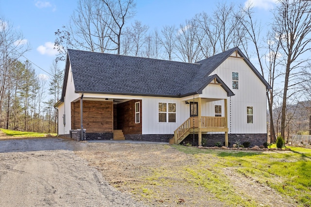 modern farmhouse style home with roof with shingles and driveway