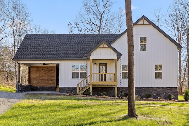 modern farmhouse featuring board and batten siding, roof with shingles, and a front lawn