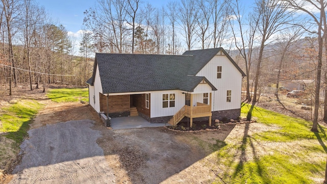 view of front of home featuring driveway and a shingled roof