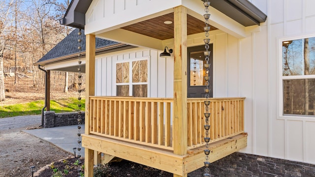 exterior space featuring roof with shingles and board and batten siding