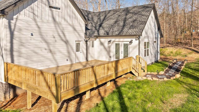 rear view of house featuring a deck, french doors, board and batten siding, and a shingled roof