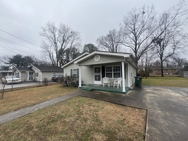 view of front of house with a porch and a front yard