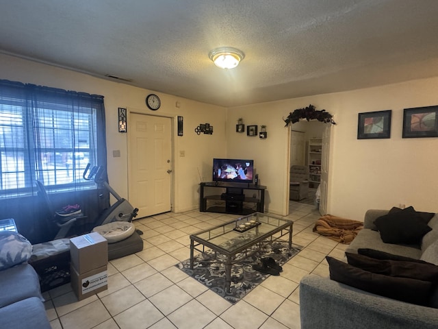 living room featuring light tile patterned floors and a textured ceiling