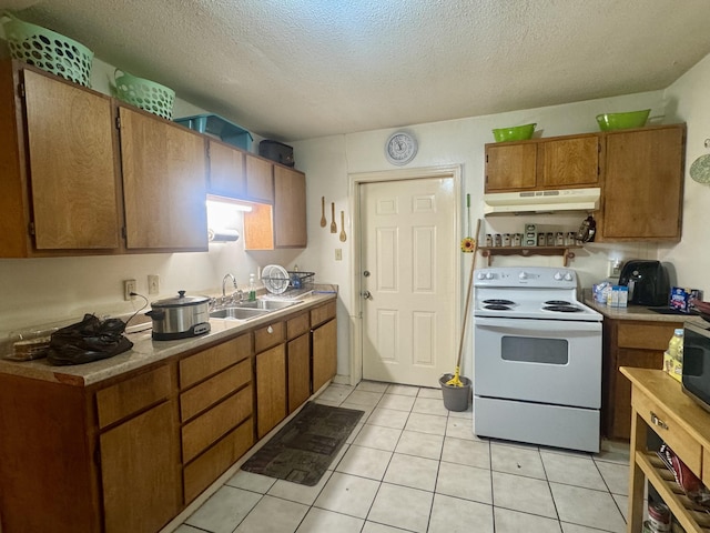 kitchen with sink, light tile patterned floors, a textured ceiling, and white range with electric stovetop