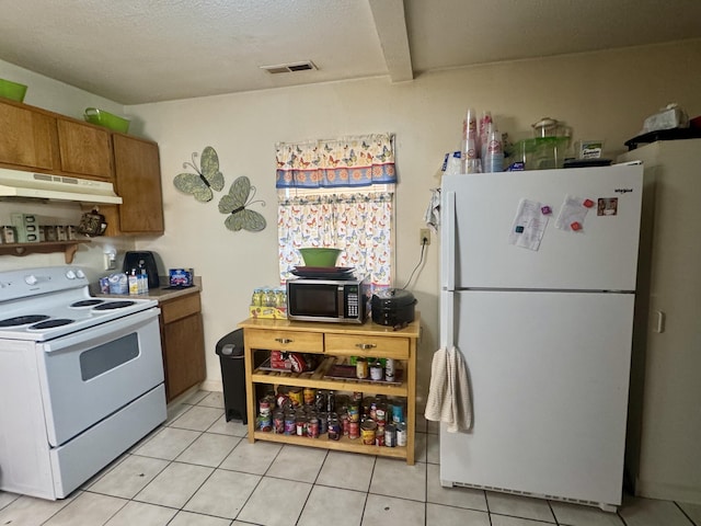 kitchen with light tile patterned floors and white appliances