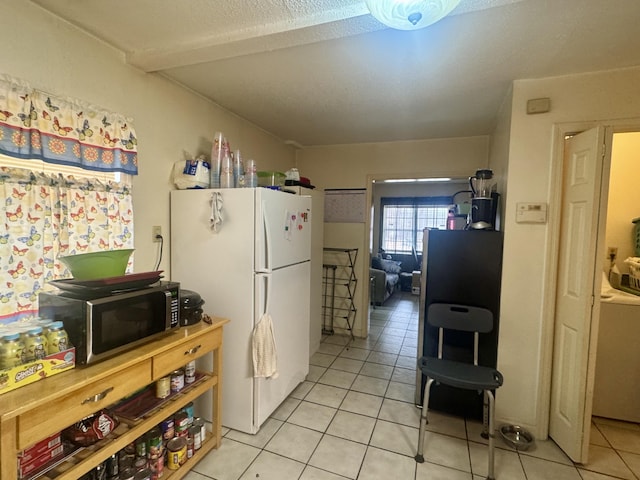 kitchen featuring white fridge and light tile patterned floors