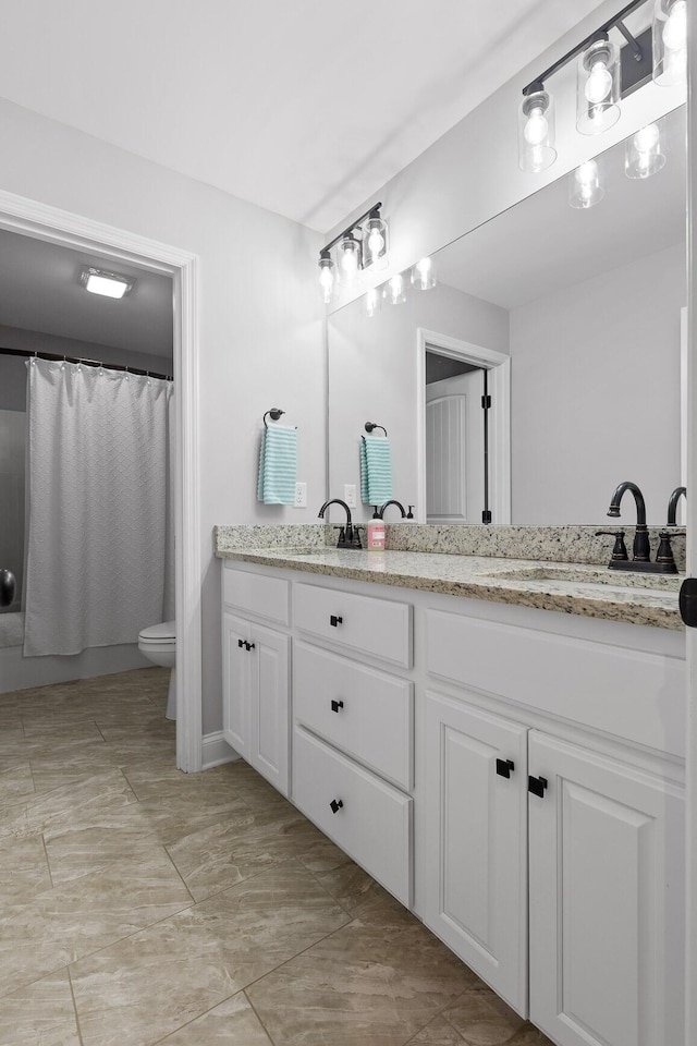 bathroom featuring vanity, toilet, and curtained shower