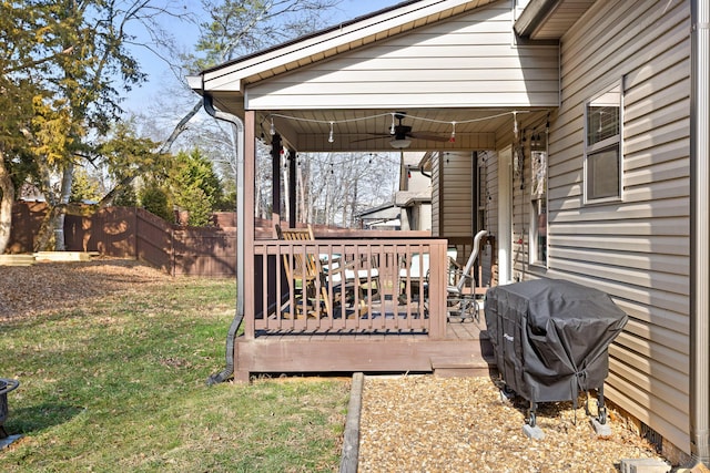 view of yard featuring ceiling fan and a deck