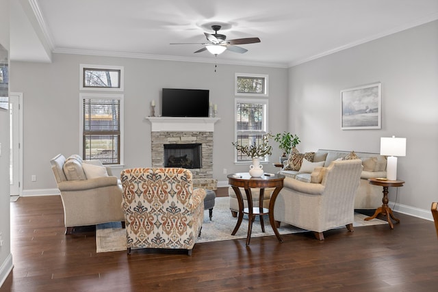 living room with crown molding, dark wood-type flooring, ceiling fan, and a fireplace