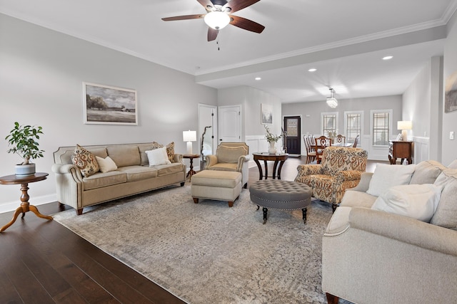 living room featuring hardwood / wood-style flooring, ornamental molding, and ceiling fan