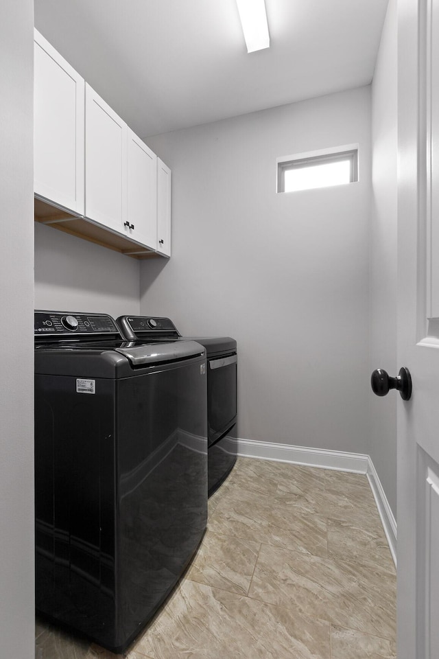 laundry room with cabinets and washing machine and clothes dryer