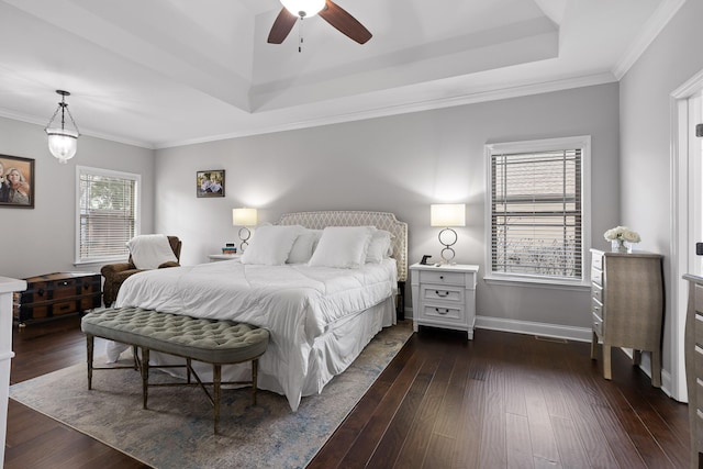 bedroom with a raised ceiling, ornamental molding, and dark hardwood / wood-style flooring