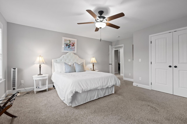 bedroom with ceiling fan, carpet flooring, and a closet