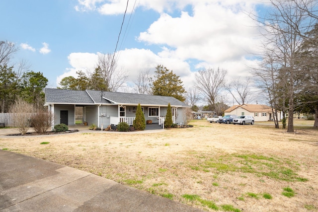 ranch-style home with a porch and a front yard