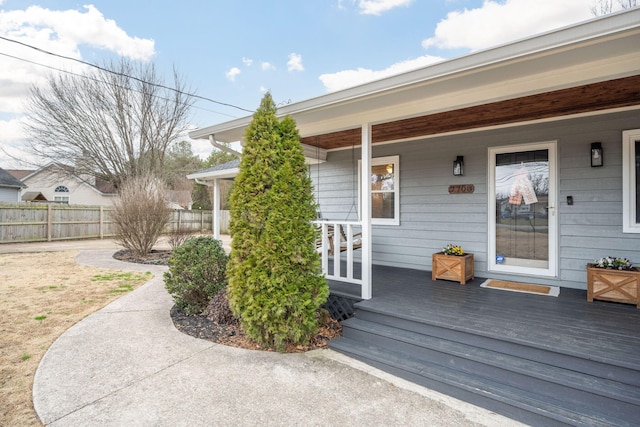 view of exterior entry with a porch